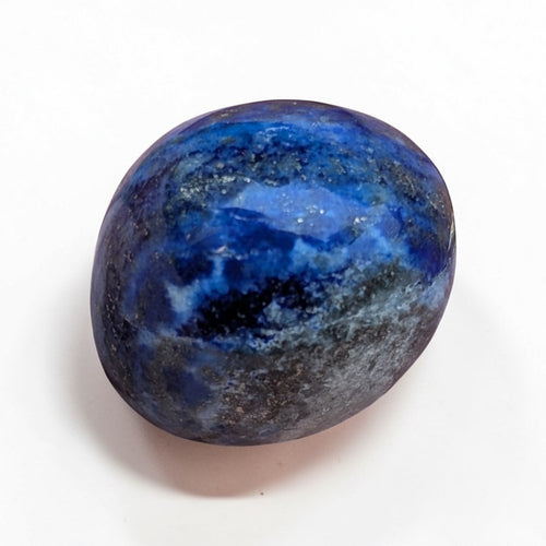 Lapis Lazuli Tumble Stone - Polished, one polished deep blue lapis lazuli tumble stone with golden flecks on a white background.